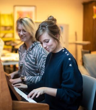 Twee vrouwen spelen samen piano